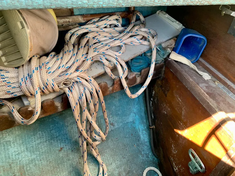 Slide: The Image of Coiled ropes and equipment in a 1986 Sabre 36 sailboat interior. - 45
