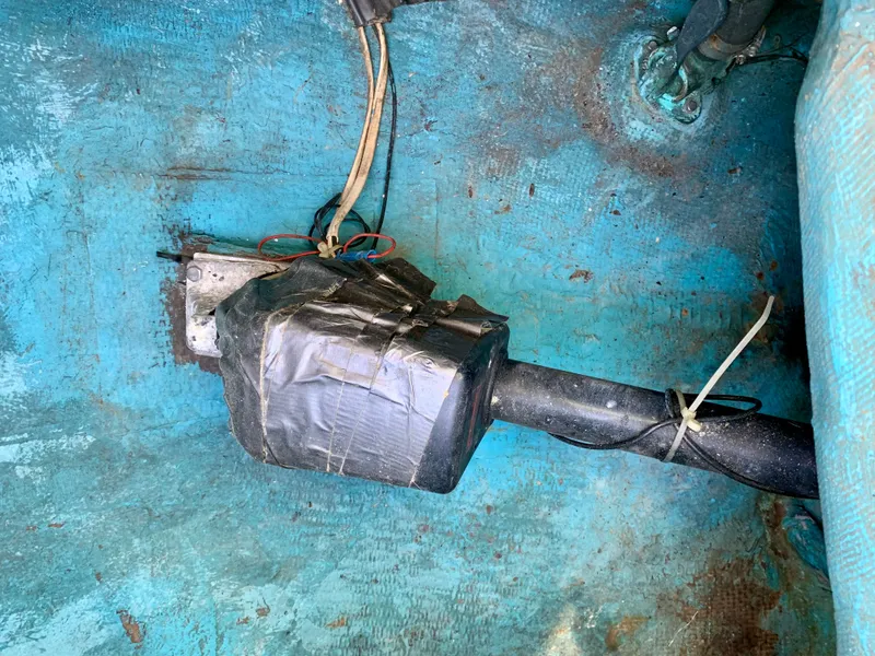Slide: The Image of A 1986 Sabre 36 boat component with wires and duct tape in a blue interior. - 46