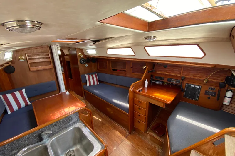 Slide: The Image of Interior of 1986 Sabre 36 sailboat with wood finish, seating, and navigation area. - 5