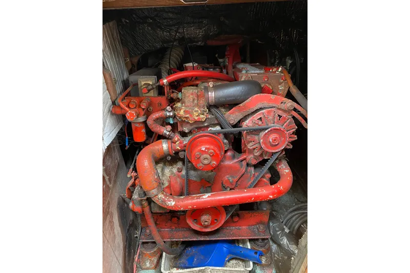 Slide: The Image of Red engine of a 1986 Sabre 36 boat, showing belts and hoses. - 52