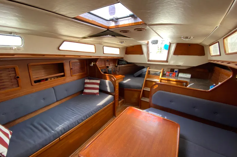 Slide: The Image of Interior of 1986 Sabre 36 sailboat with wooden finish and blue seating. - 6