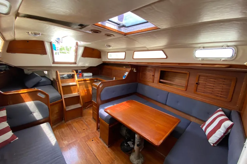 Slide: The Image of Interior of 1986 Sabre 36 sailboat with wooden furnishings and blue seating. - 7
