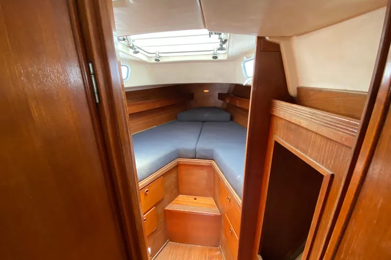 Slide: The Image of 1986 Sabre 36 sailboat cabin interior with wooden finish and cozy sleeping area. - 8
