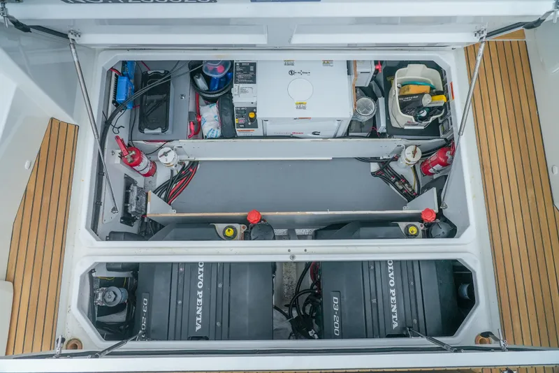 Slide: The Image of Engine compartment of a 2017 Jeanneau NC11 boat, featuring Volvo Penta engines and equipment. - 11