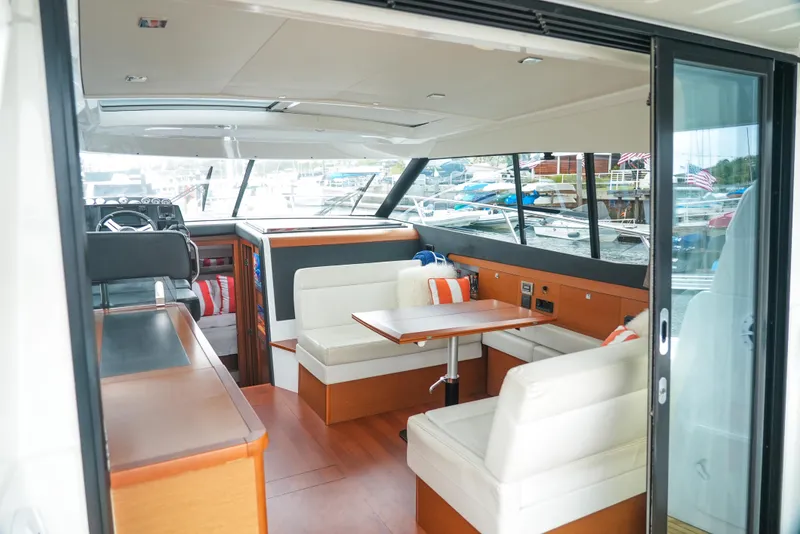 Slide: The Image of Interior of 2017 Jeanneau NC11 yacht with seating and table, featuring modern design. - 13