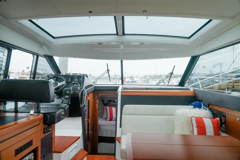 Slide: The Image of Interior of 2017 Jeanneau NC11 boat with modern helm and seating area. - 17