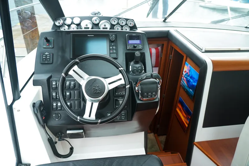 Slide: The Image of Cockpit of 2017 Jeanneau NC11 boat with modern steering and control panel. - 20