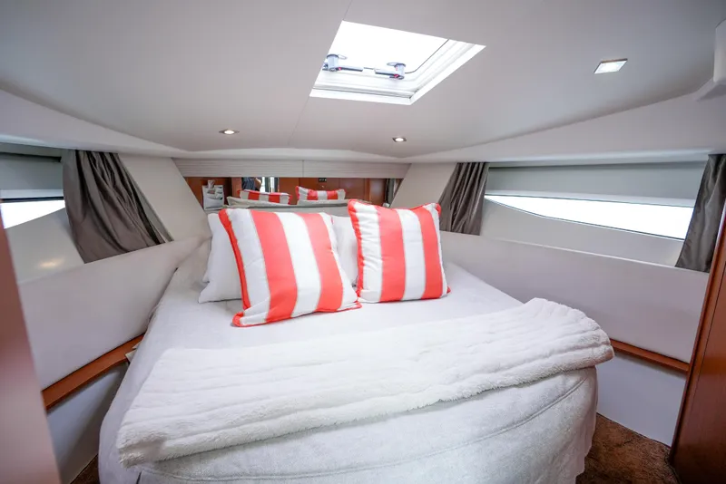 Slide: The Image of Luxurious cabin interior of 2017 Jeanneau NC11 with striped pillows and skylight. - 21