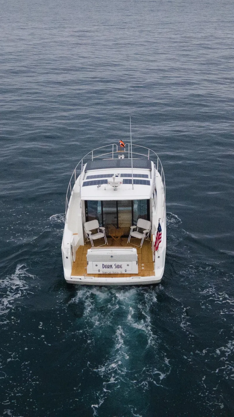 Slide: The Image of 2017 Jeanneau NC11 boat cruising on open water, rear view. - 4