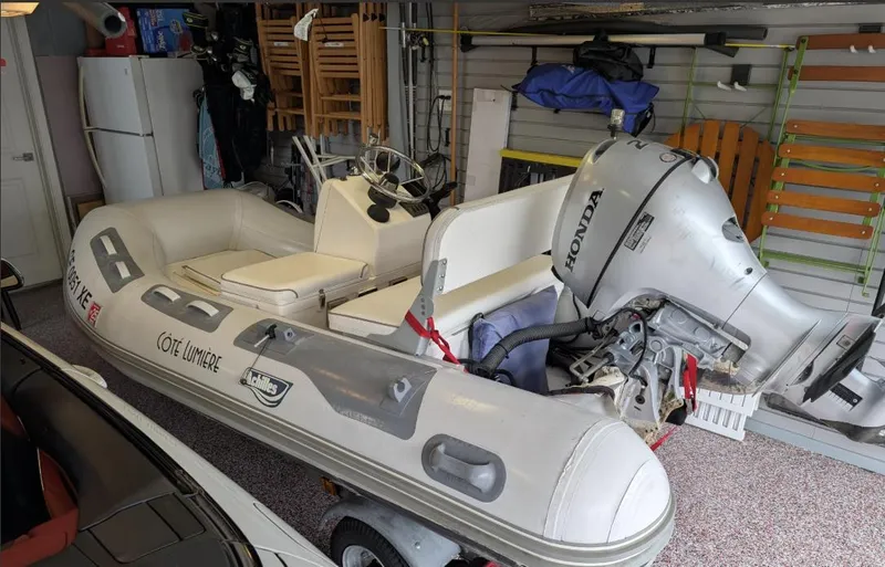 Slide: The Image of Inflatable boat with Honda outboard motor stored in a garage. - 7