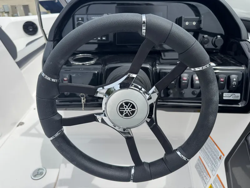 Slide: The Image of Steering wheel of 2025 Yamaha Boats 195S, featuring sleek design and control panel. - 18