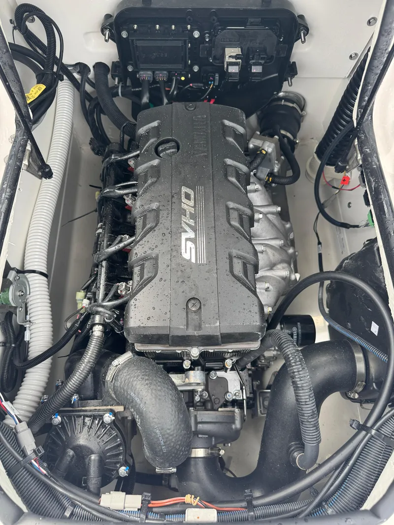 Slide: The Image of 2025 Yamaha Boats 195S engine compartment with SVHO motor, showcasing intricate components and wiring. - 19