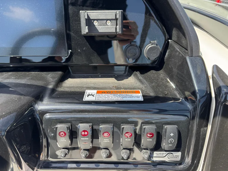 Slide: The Image of Control panel of 2025 Yamaha Boats 195S, featuring multiple switches and power outlets. - 19