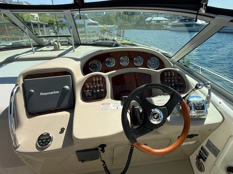 Slide: The Image of Helm of 2008 Sea Ray 340 Sundancer with Raymarine navigation, docked by the water. - 14