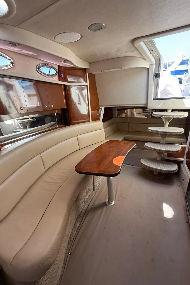 Slide: The Image of 2008 Sea Ray 340 Sundancer interior with beige seating and wooden table. - 20
