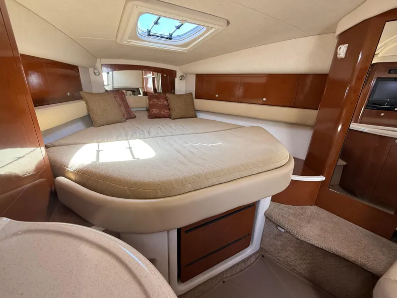 Slide: The Image of Luxurious cabin interior of 2008 Sea Ray 340 Sundancer with cozy bed and elegant wood finish. - 22