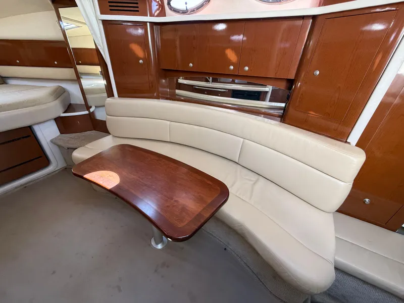 Slide: The Image of Interior of 2008 Sea Ray 340 Sundancer with beige seating and wooden table. - 24