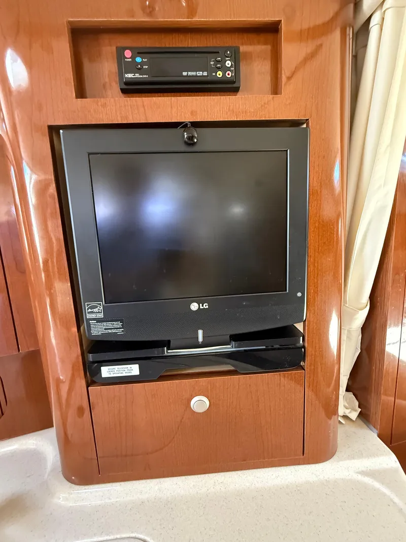 Slide: The Image of LG TV and control panel in 2008 Sea Ray 340 Sundancer yacht interior. - 26