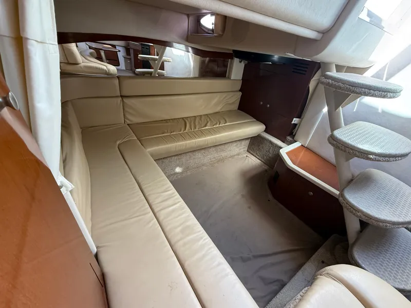 Slide: The Image of Interior of 2008 Sea Ray 340 Sundancer with beige seating and carpeted stairs. - 27