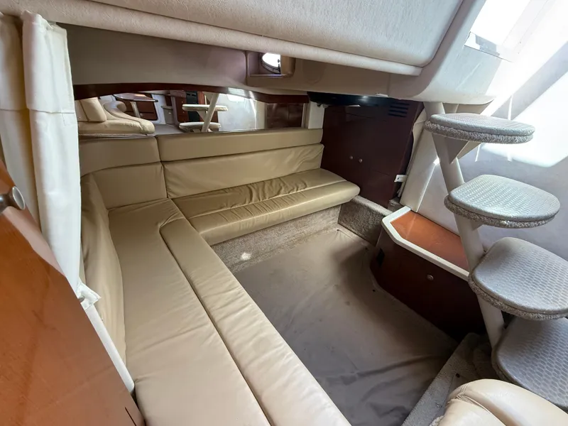 Slide: The Image of 2008 Sea Ray 340 Sundancer interior with beige seating and carpeted steps. - 28