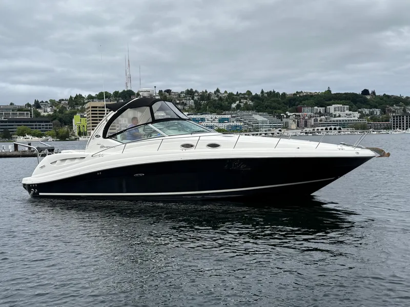 Slide: The Image of 2008 Sea Ray 340 Sundancer yacht on calm water with cityscape background. - 5