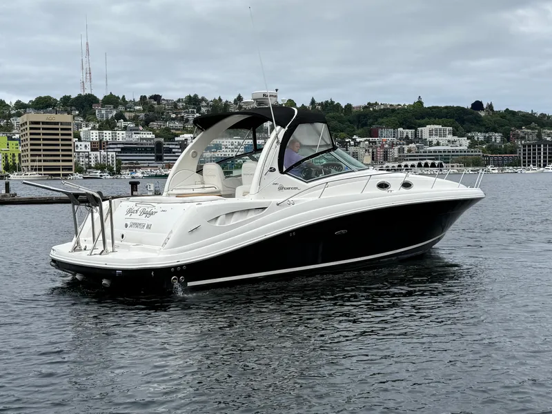 Slide: The Image of 2008 Sea Ray 340 Sundancer yacht on calm water with cityscape background. - 6