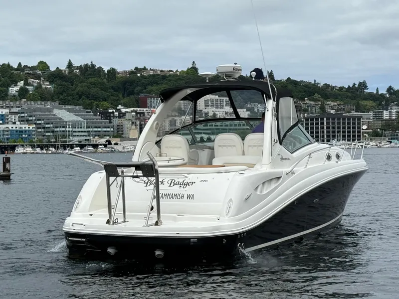 Slide: The Image of 2008 Sea Ray 340 Sundancer boat on water, cityscape in background. - 7