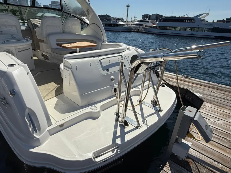 Slide: The Image of 2008 Sea Ray 340 Sundancer yacht docked, showcasing spacious deck and seating area. - 9