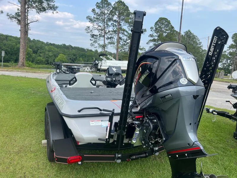 Slide: The Image of 2025 Skeeter ZXR 20 boat with powerful outboard motor, parked on grass, showcasing sleek design. - 3
