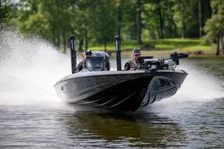 Slide: The Image of 2025 Skeeter ZXR 20 boat speeding on a lake with two passengers. - 8