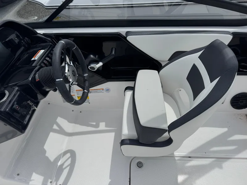 Slide: The Image of 2025 Yamaha Boats 195S cockpit with steering wheel and cushioned seat. - 14