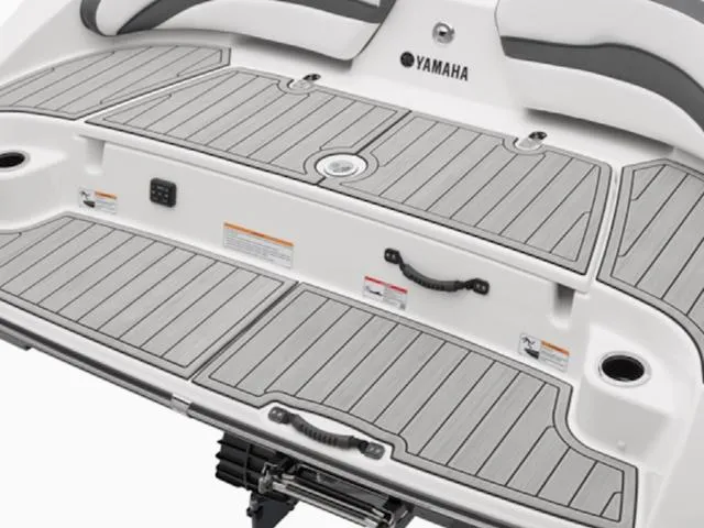 Slide: The Image of 2025 Yamaha Boats 195S swim platform with gray decking and integrated handles. - 24