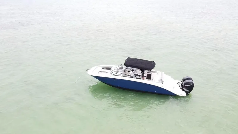 Slide: The Image of 2017 Sea Ray SDX 290 Outboard boat on calm water, featuring a sleek design and black canopy. - 12