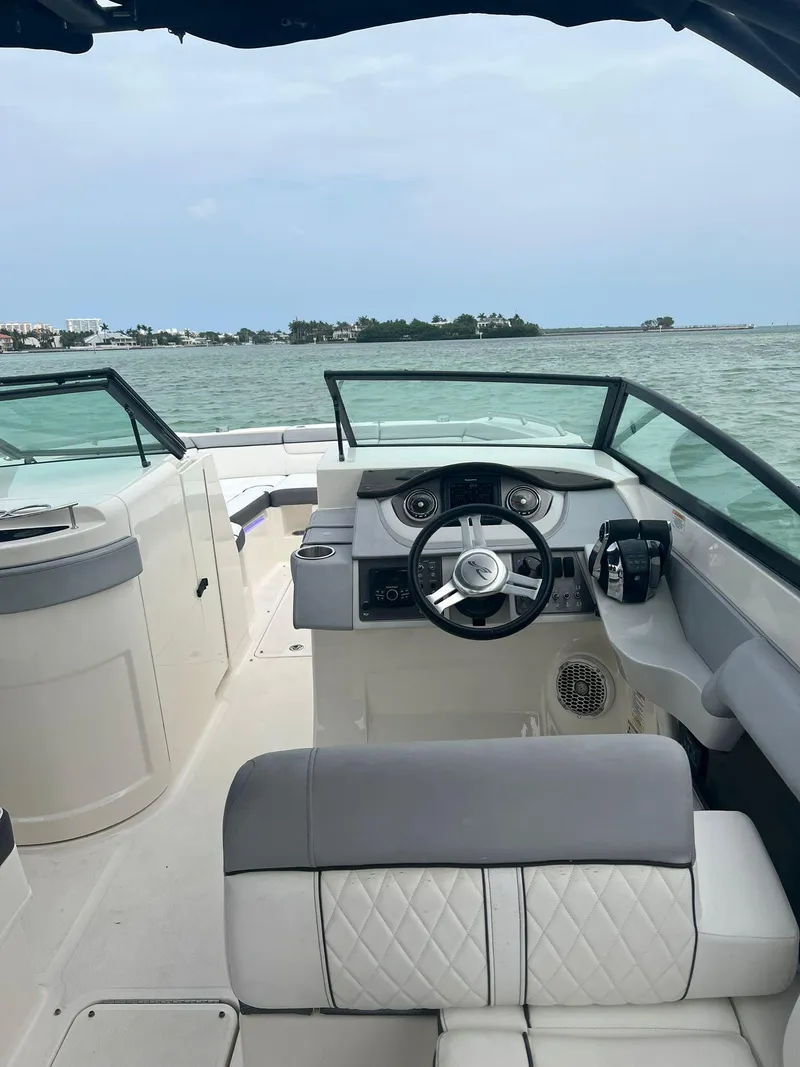 Slide: The Image of 2017 Sea Ray SDX 290 Outboard boat interior with steering wheel, on open water. - 16