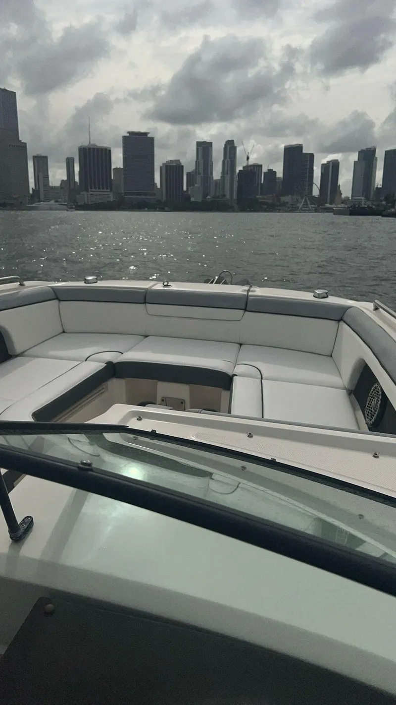 Slide: The Image of 2017 Sea Ray SDX 290 Outboard boat with city skyline in the background. - 17