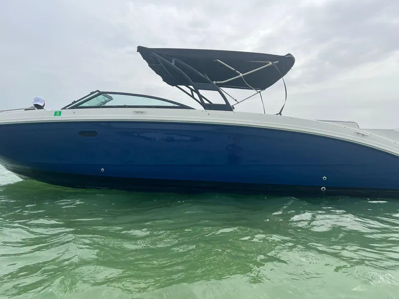 Slide: The Image of 2017 Sea Ray SDX 290 Outboard boat with blue hull on calm water. - 18