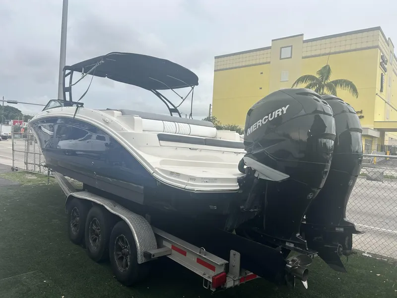 Slide: The Image of 2017 Sea Ray SDX 290 Outboard boat with twin Mercury engines on a trailer. - 2