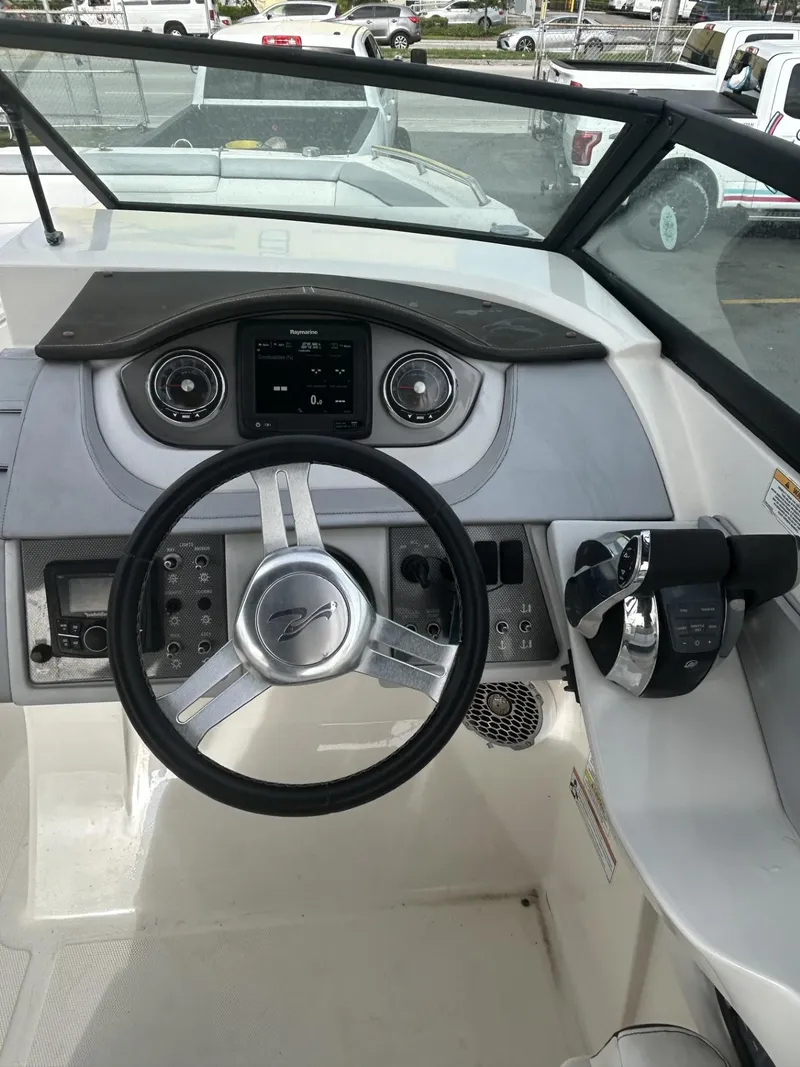 Slide: The Image of 2017 Sea Ray SDX 290 Outboard helm with steering wheel and control panel. - 22