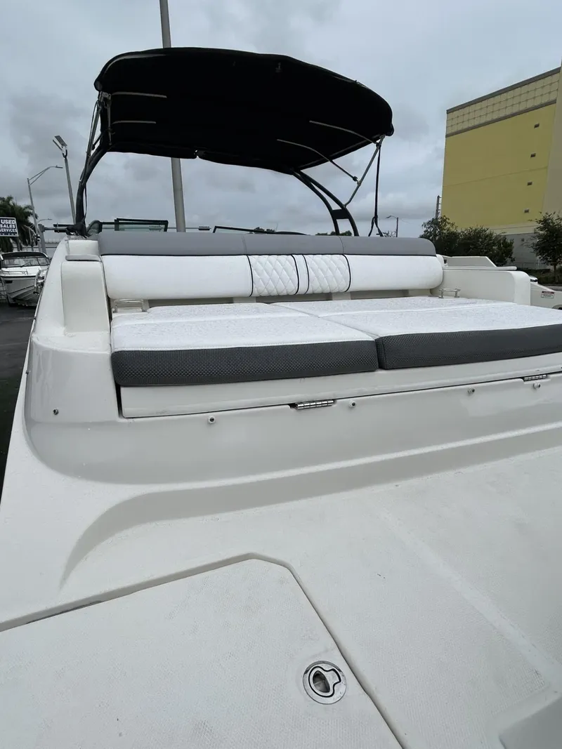 Slide: The Image of 2017 Sea Ray SDX 290 Outboard boat with cushioned seating and canopy, docked outdoors. - 24