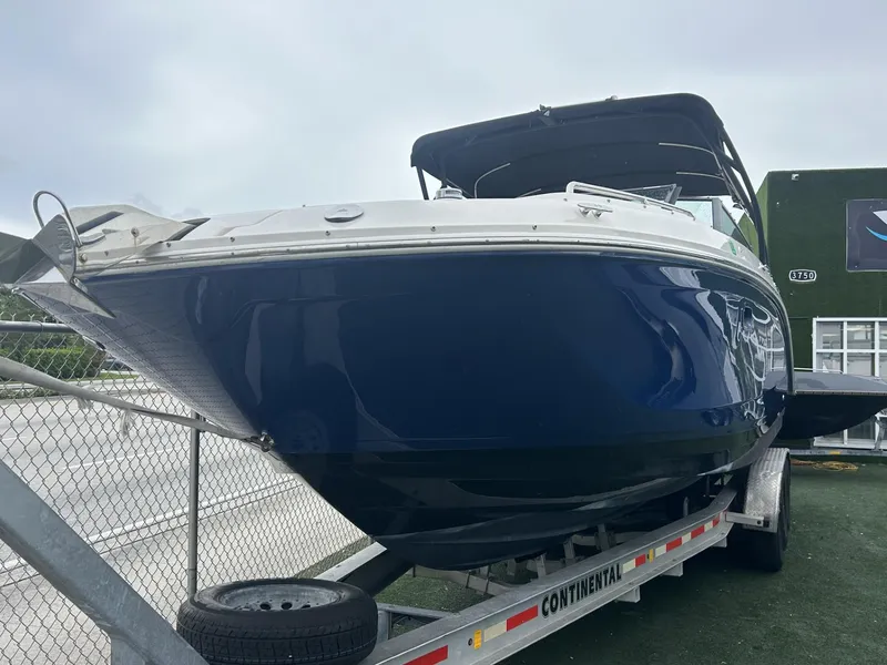 Slide: The Image of 2017 Sea Ray SDX 290 Outboard boat on trailer, blue hull, parked outdoors. - 3