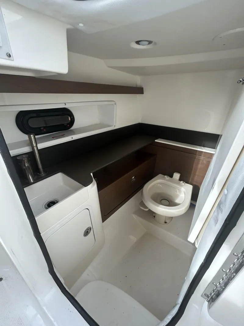 Slide: The Image of 2017 Sea Ray SDX 290 Outboard boat interior with sink and toilet. - 6