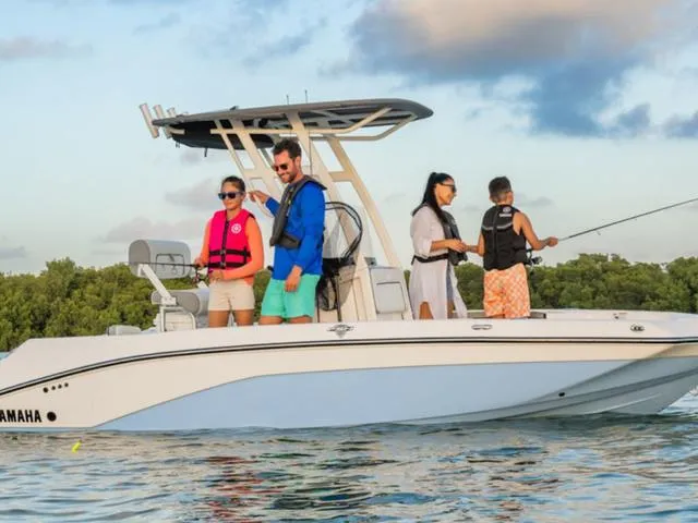 Slide: The Image of 2025 Yamaha Boats 195 FSH Sport on water with people fishing and enjoying the ride. - 4