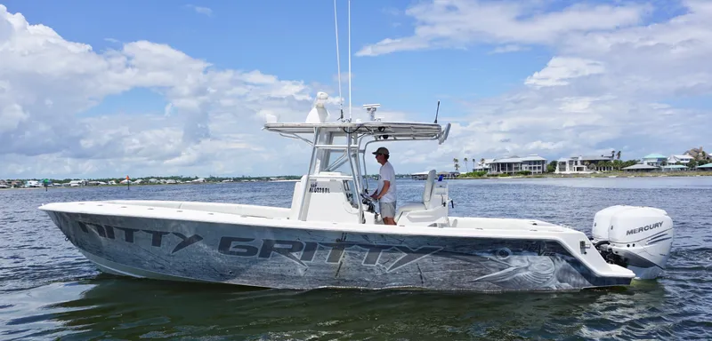 Slide: The Image of 2009 SeaVee 32OB boat on water, featuring sleek design and Mercury outboard engine. - 1