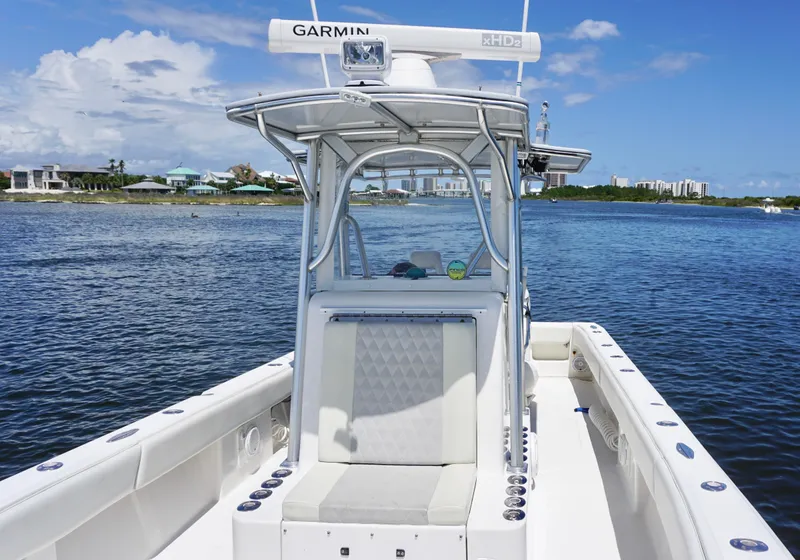 Slide: The Image of 2009 SeaVee 32OB boat with Garmin equipment on calm water, clear sky background. - 11