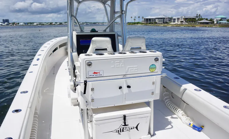 Slide: The Image of 2009 SeaVee 32OB boat on water, featuring center console and seating, under a partly cloudy sky. - 13