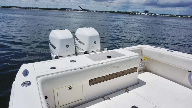 Slide: The Image of 2009 SeaVee 32OB boat with twin outboard engines on a calm water backdrop. - 17