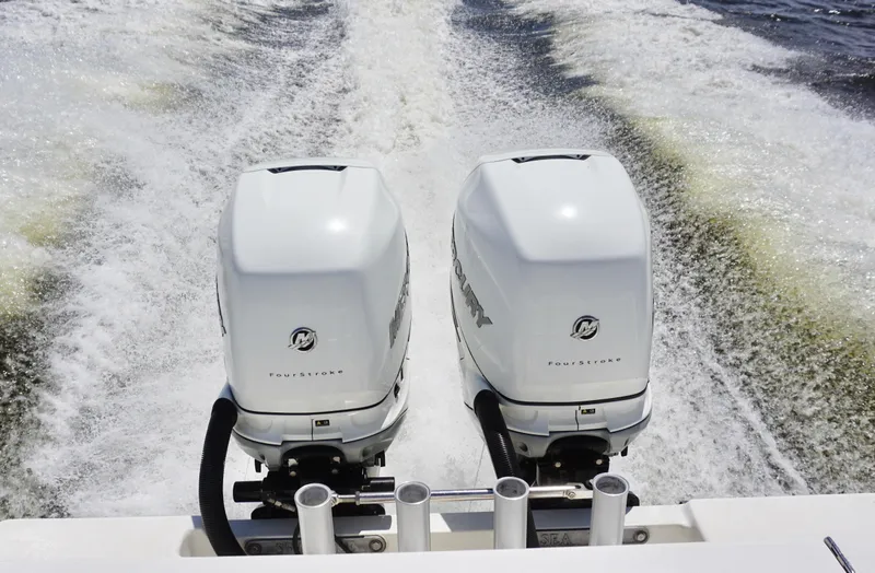Slide: The Image of Twin Mercury outboard engines on a 2009 SeaVee 32OB boat, creating a wake. - 21