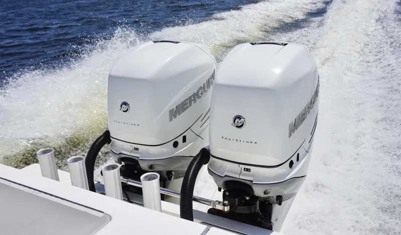 Slide: The Image of Twin Mercury outboard engines on a 2009 SeaVee 32OB boat cruising on water. - 22