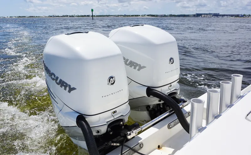 Slide: The Image of Twin Mercury outboard engines on a 2009 SeaVee 32OB boat cruising on open water. - 24