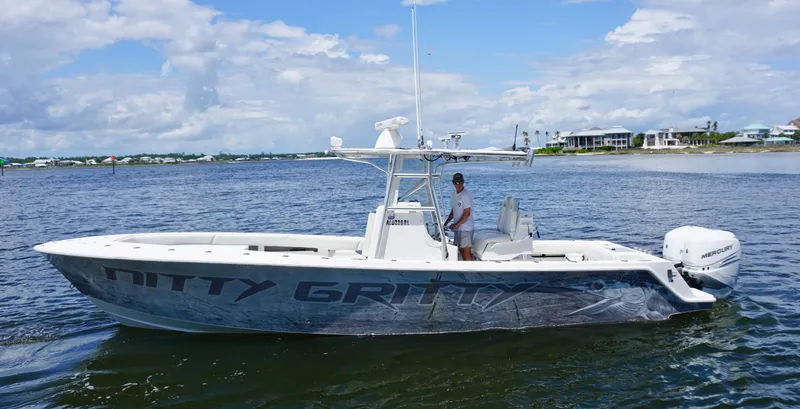 Slide: The Image of 2009 SeaVee 32OB boat on water, clear sky, person at helm. - 5
